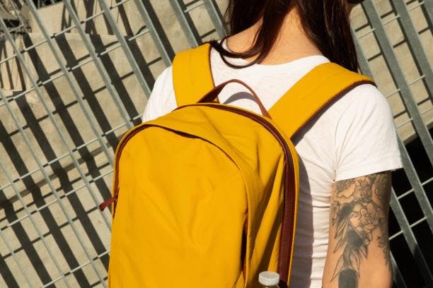 Person showing off the exterior of the Everything Backpack by Moment.